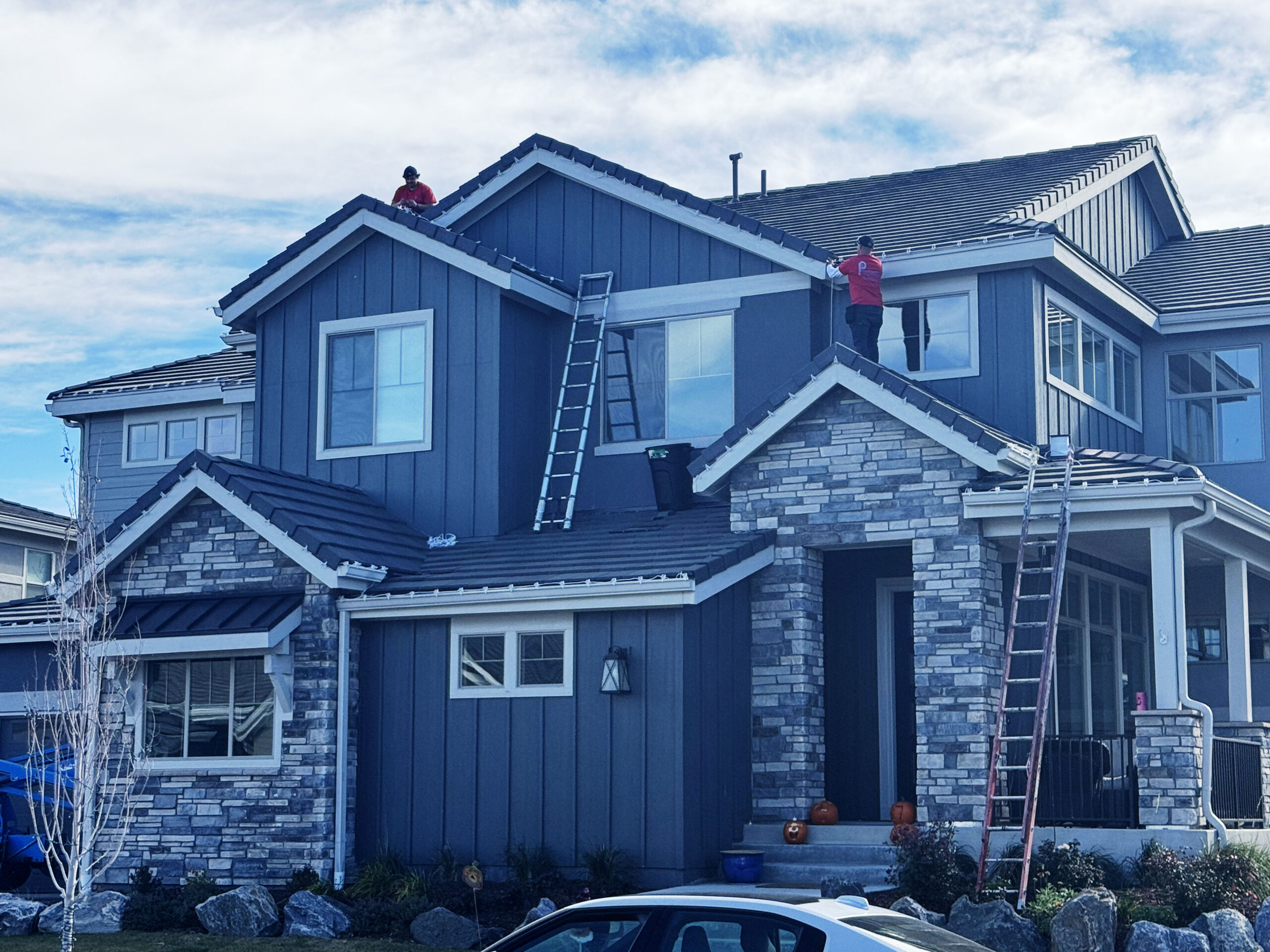 Professional residential Christmas lighting on a Denver home roofline.